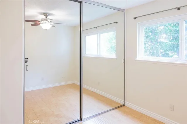 a view of a livingroom with a ceiling fan and window