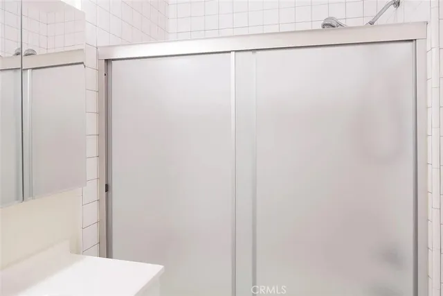 a bathroom with a shower and a toilet