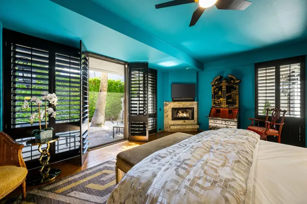 a bed sitting in a spacious bedroom next to a window