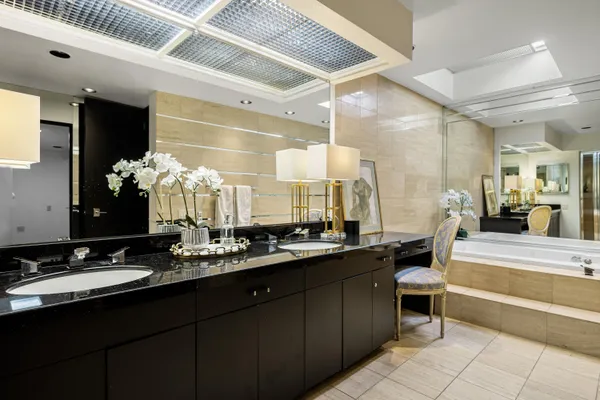 a bathroom with a double vanity sink and a mirror