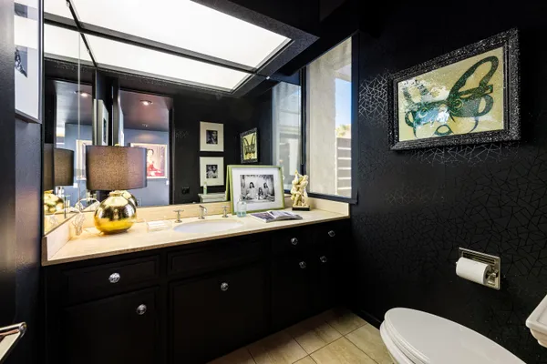 a bathroom with a toilet sink and mirror