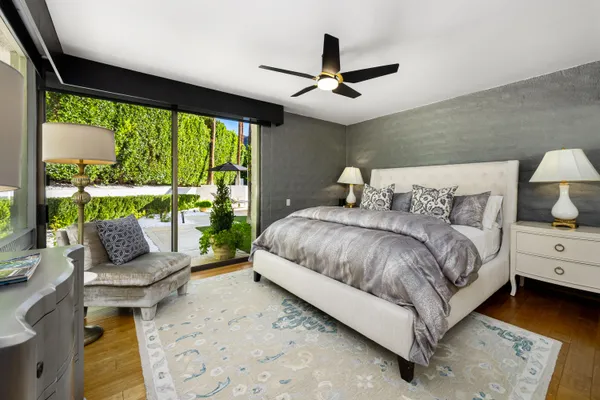 a bedroom with a bed and large window