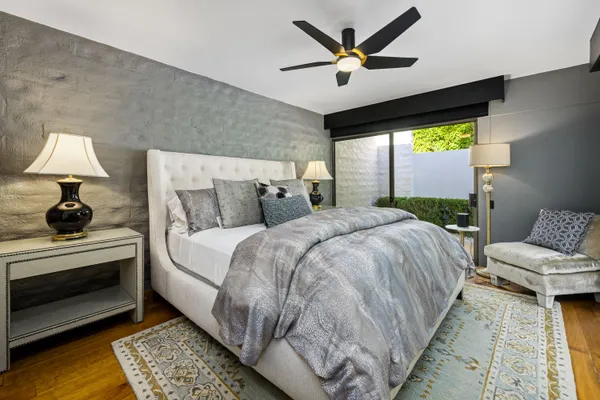 a bedroom with a bed and a large window