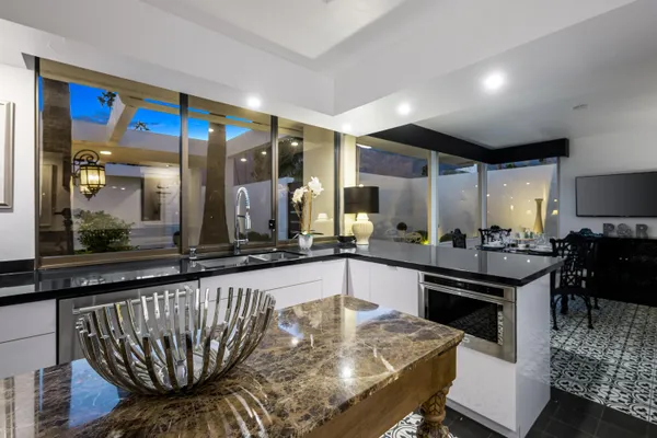 a kitchen with stainless steel appliances granite countertop a sink and cabinets