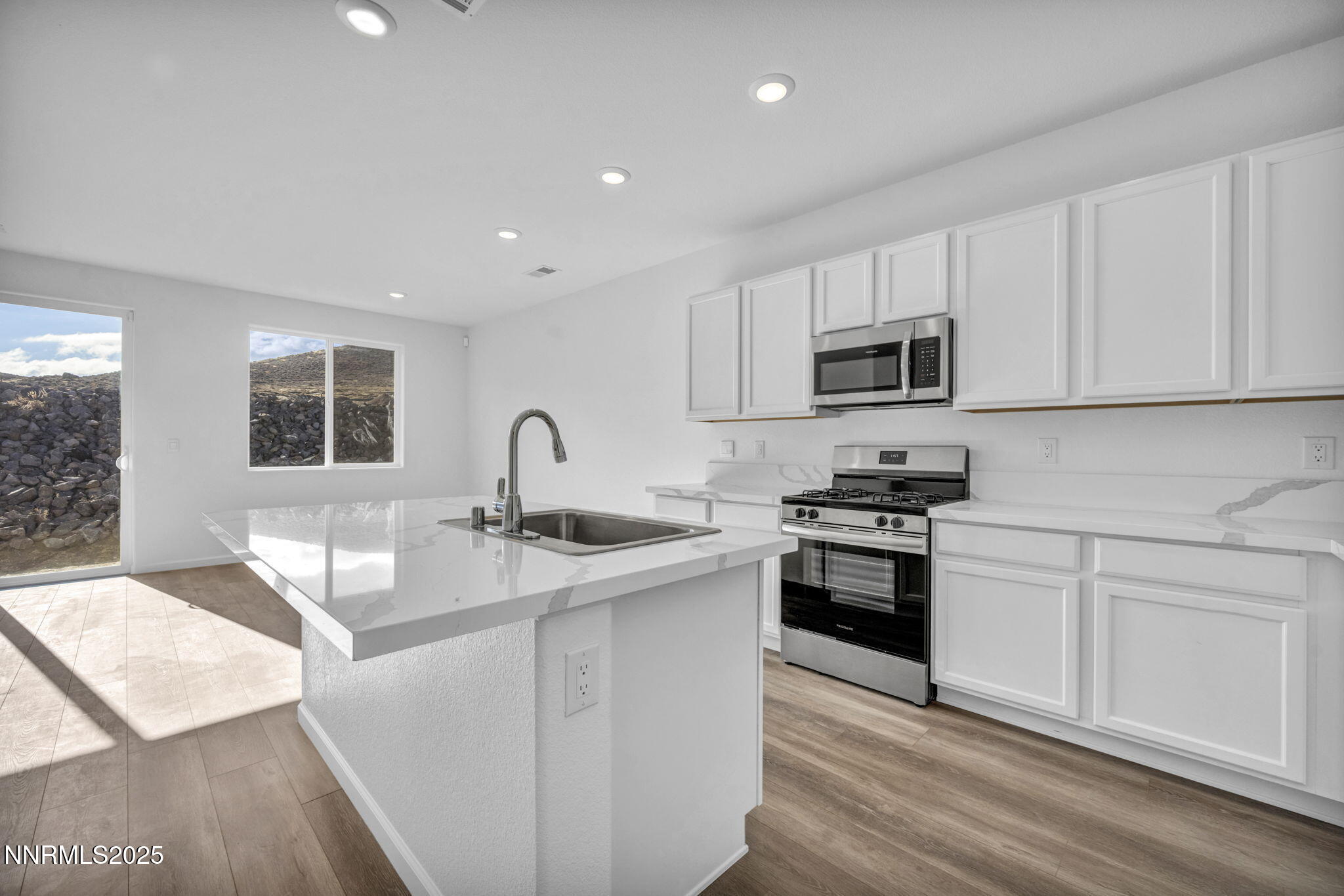 8470 Endor Drive, Unit LOT 15 Reno, NV 89506 - Photo 13 of 27 a kitchen with stainless steel appliances granite countertop a sink and white cabinets