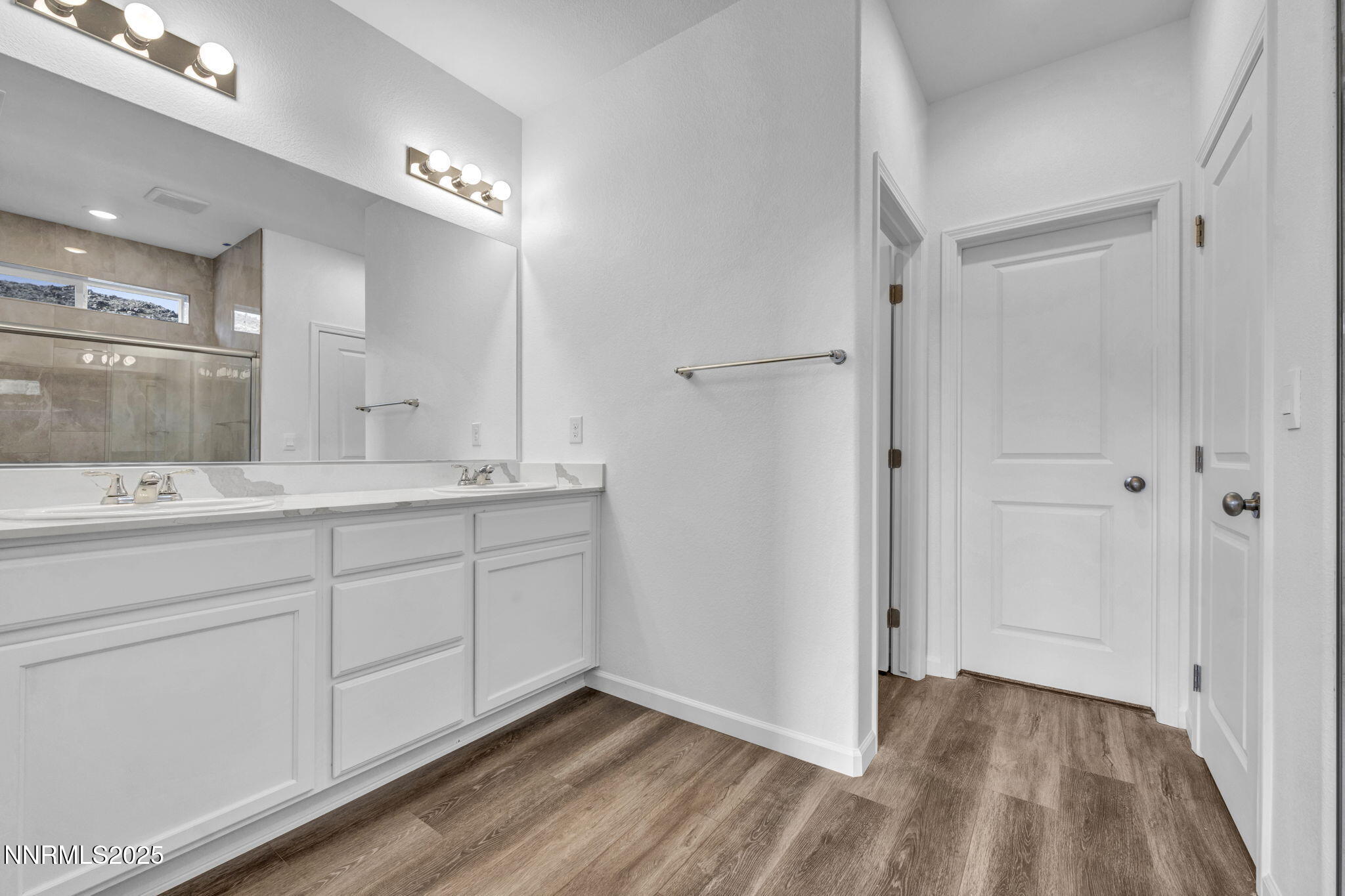 8470 Endor Drive, Unit LOT 15 Reno, NV 89506 - Photo 15 of 27 a bathroom with a double vanity sink and mirror
