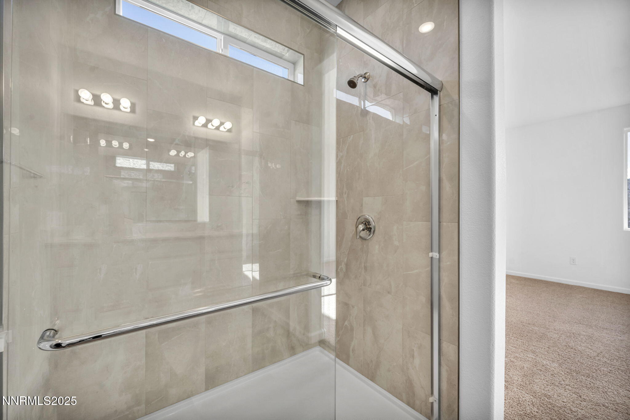 8470 Endor Drive, Unit LOT 15 Reno, NV 89506 - Photo 17 of 27 a bathroom with a glass shower door