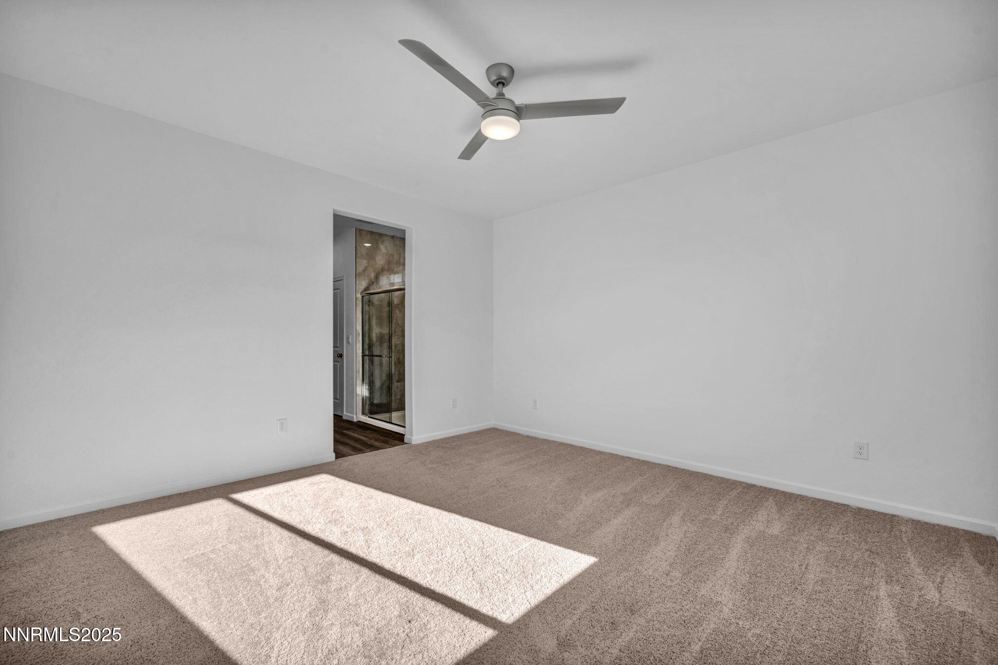 8470 Endor Drive, Unit LOT 15 Reno, NV 89506 - Photo 25 of 27 an empty room with closet and ceiling fan