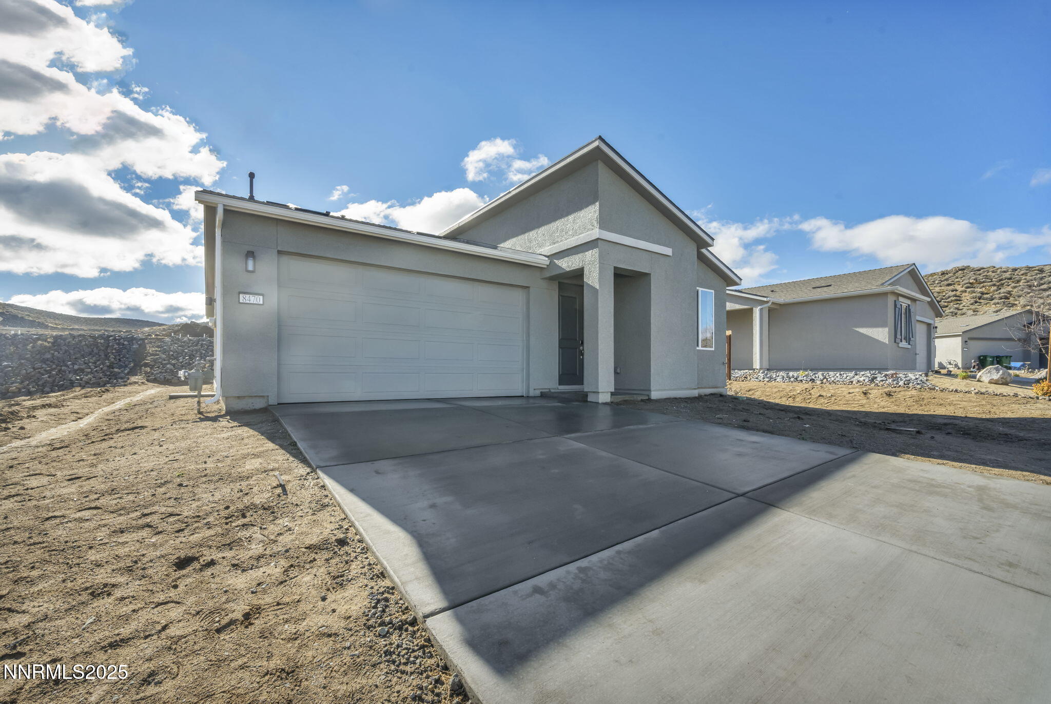 8470 Endor Drive, Unit LOT 15 Reno, NV 89506 - Photo 3 of 27 a front view of a house with a yard and garage