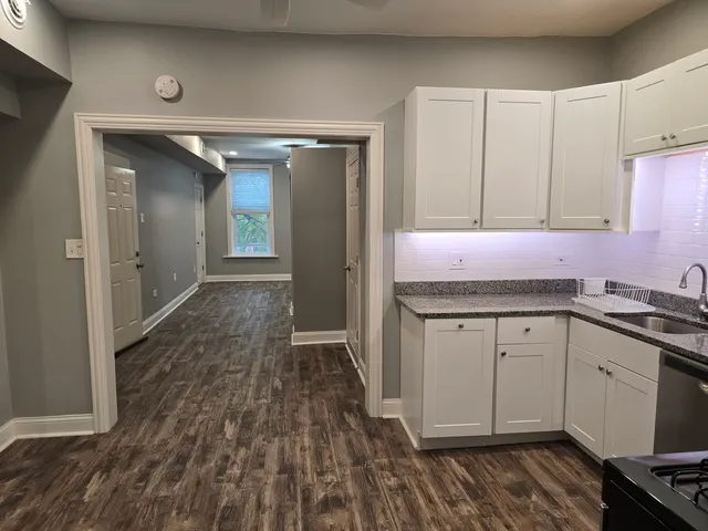 a kitchen with granite countertop a sink and cabinets