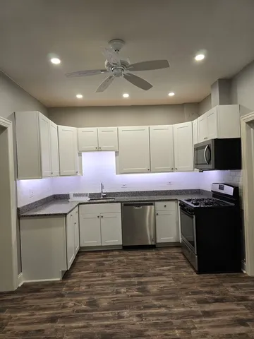 a kitchen with stainless steel appliances granite countertop a sink and cabinets