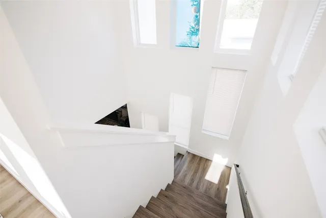 a kitchen with a sink appliances and wooden floor