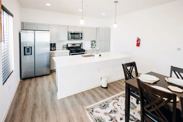 a view of a dining room with furniture and wooden floor