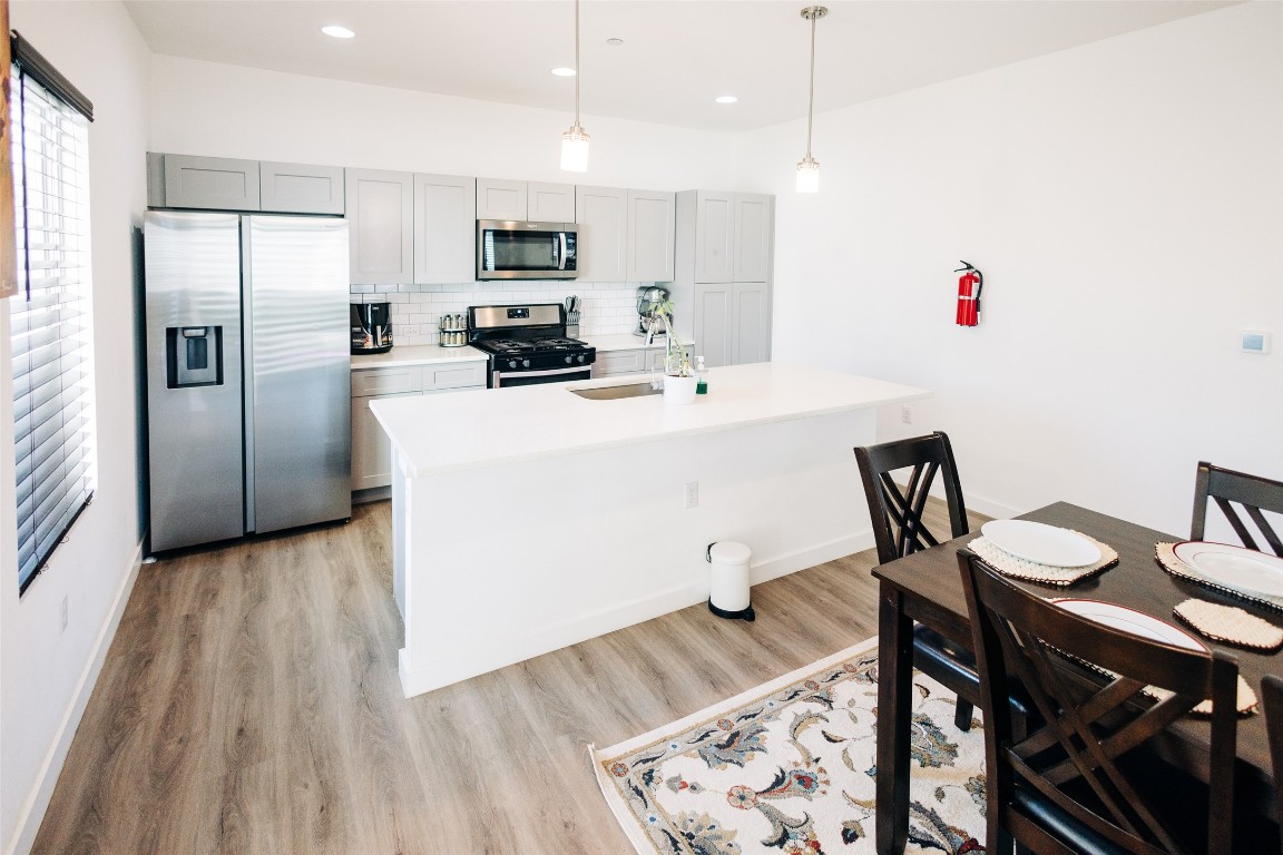 12500 Lamppost Lane, Unit 17 Austin, TX 78727 - Photo 8 of 19 a kitchen with a table chairs refrigerator and microwave
