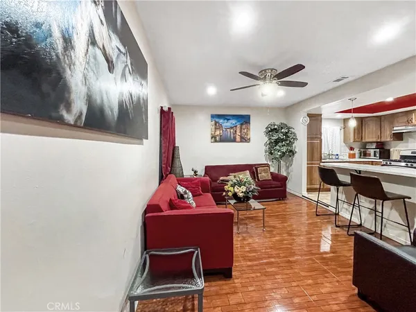 a living room with furniture and a chandelier