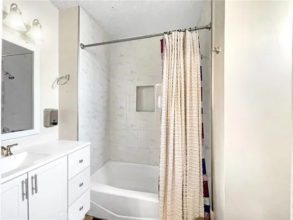a bathroom with a shower curtain and a sink