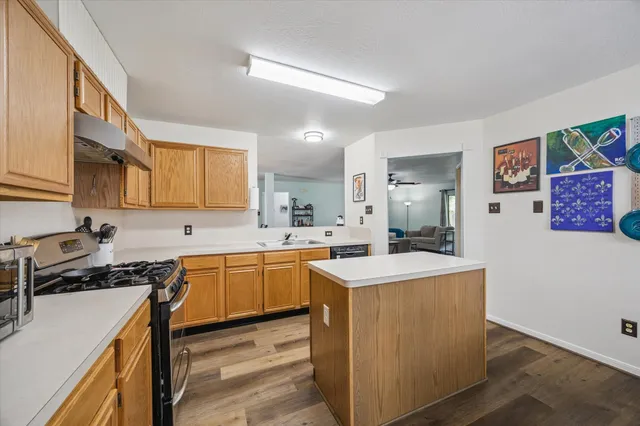 a kitchen with a sink stove top oven and cabinets