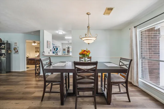 a view of a dining room with furniture window and wooden floor