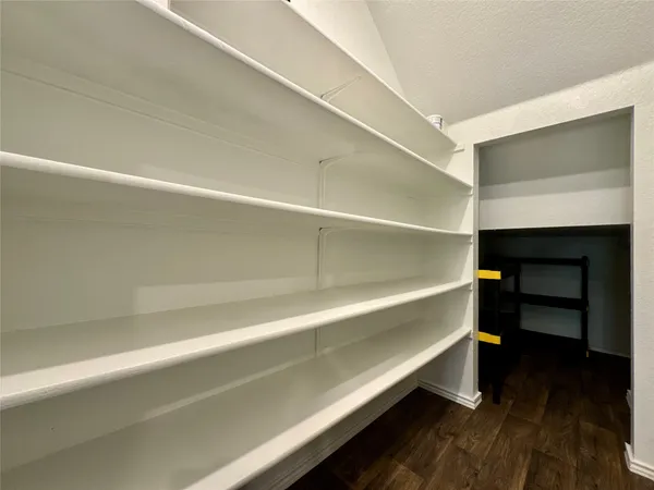 a hallway with stairs and wooden floor