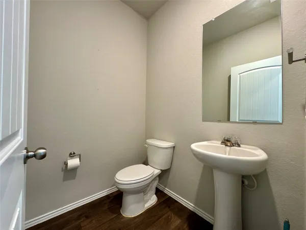 a bathroom with a sink toilet and a mirror