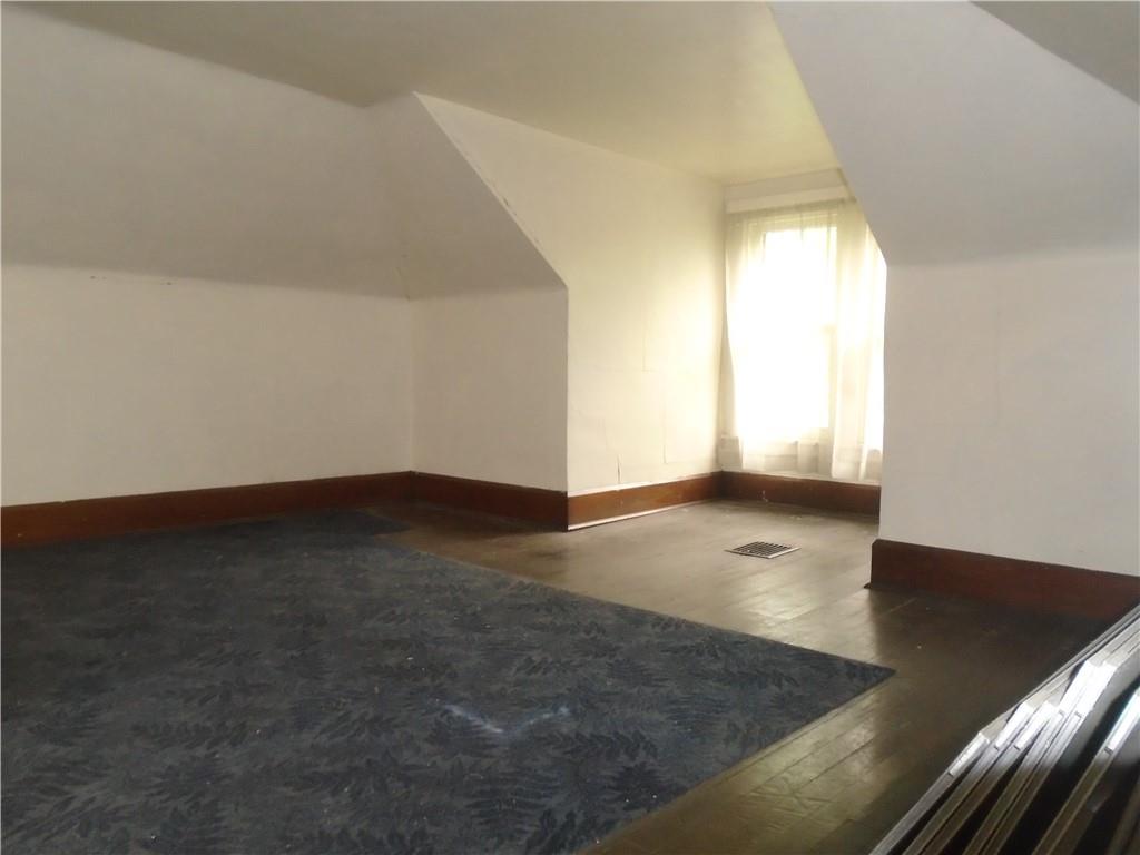 207 Locust Street Ambridge, PA 15003 - Photo 15 of 19 an empty room with wooden floor