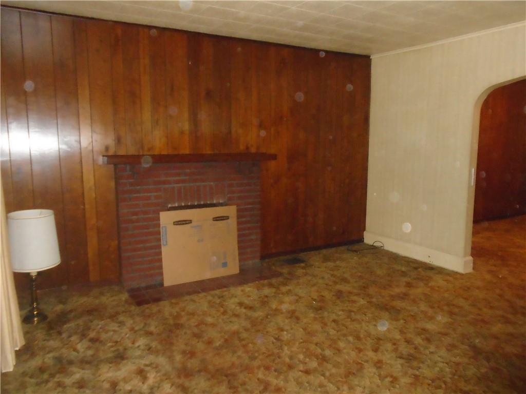 207 Locust Street Ambridge, PA 15003 - Photo 4 of 19 a view of an empty room with wooden floor and a cabinet