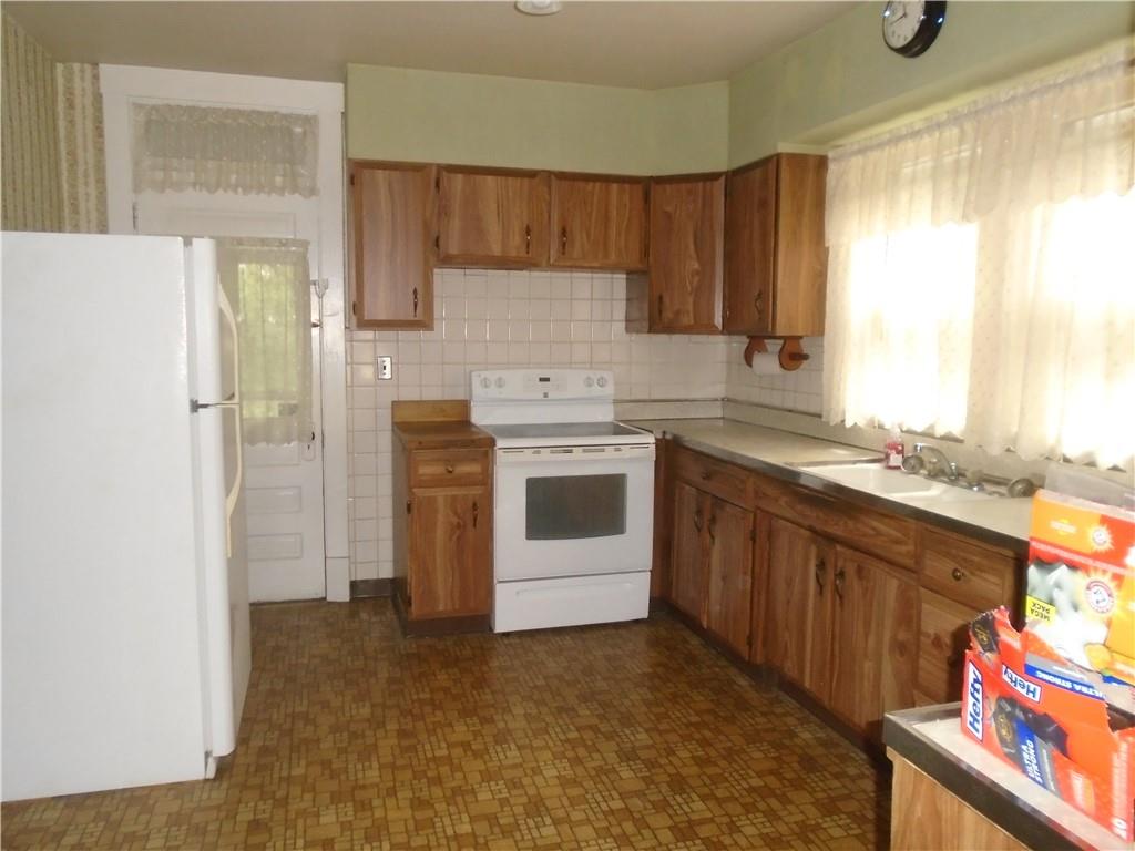 207 Locust Street Ambridge, PA 15003 - Photo 8 of 19 a kitchen with stainless steel appliances granite countertop a refrigerator sink and cabinets