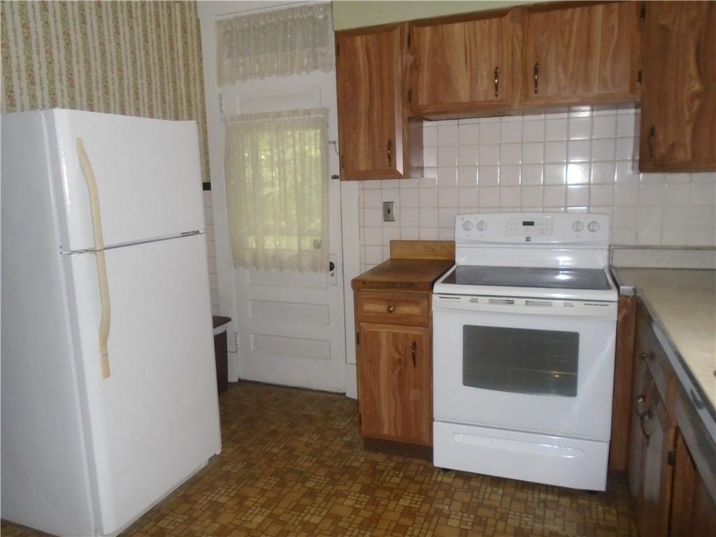 207 Locust Street Ambridge, PA 15003 - Photo 10 of 19 a kitchen with a stove a refrigerator and a sink