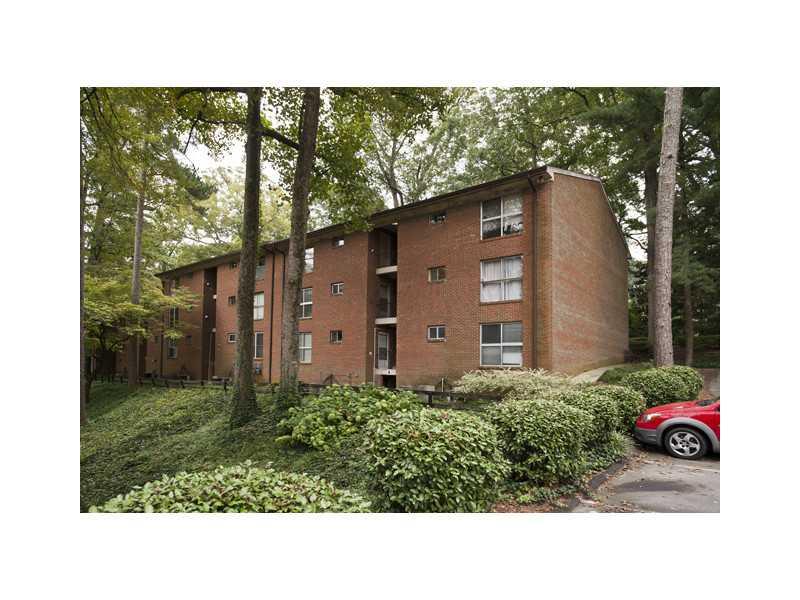 Exterior Front. Complex has swimming pool and wooded walking areas.