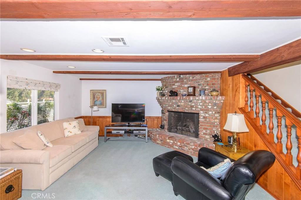 2721 Coral Ridge Road Rancho Palos Verdes, CA 90275 - Photo 9 of 24 a living room with furniture a fireplace and a flat screen tv