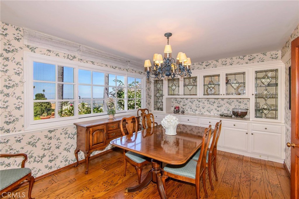 2721 Coral Ridge Road Rancho Palos Verdes, CA 90275 - Photo 10 of 24 a view of a dining room with furniture a chandelier and wooden floor