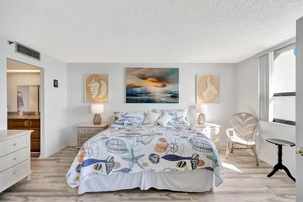 a bedroom with two beds and a chandelier