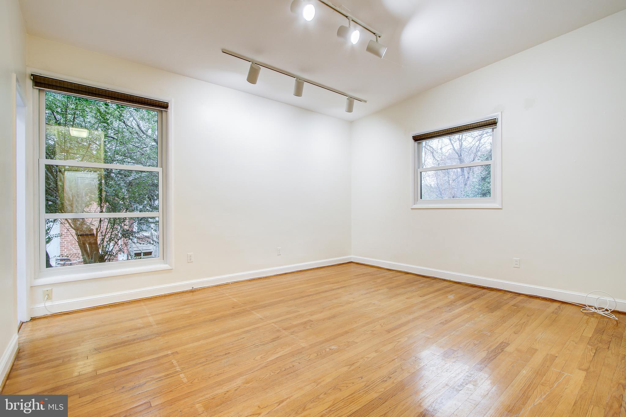6006 28th Street Northwest Washington, DC 20015 - Photo 13 of 30 wooden floor in an empty room with a window