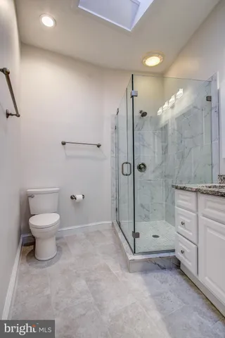a bathroom with a shower a toilet and a sink