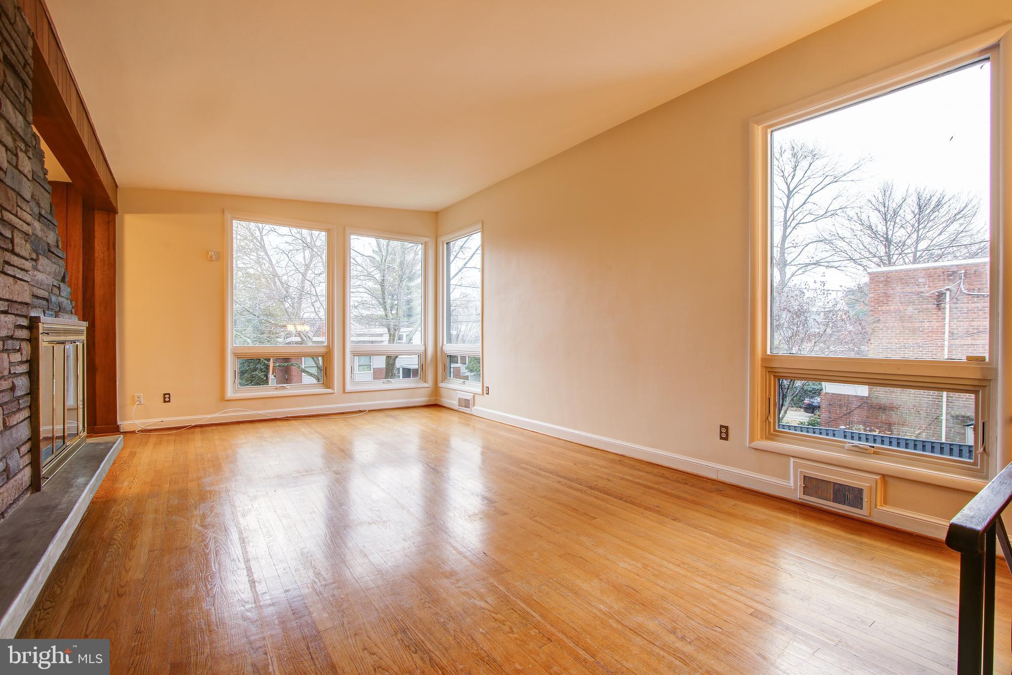 6006 28th Street Northwest Washington, DC 20015 - Photo 5 of 30 a view of an empty room with a window and wooden floor