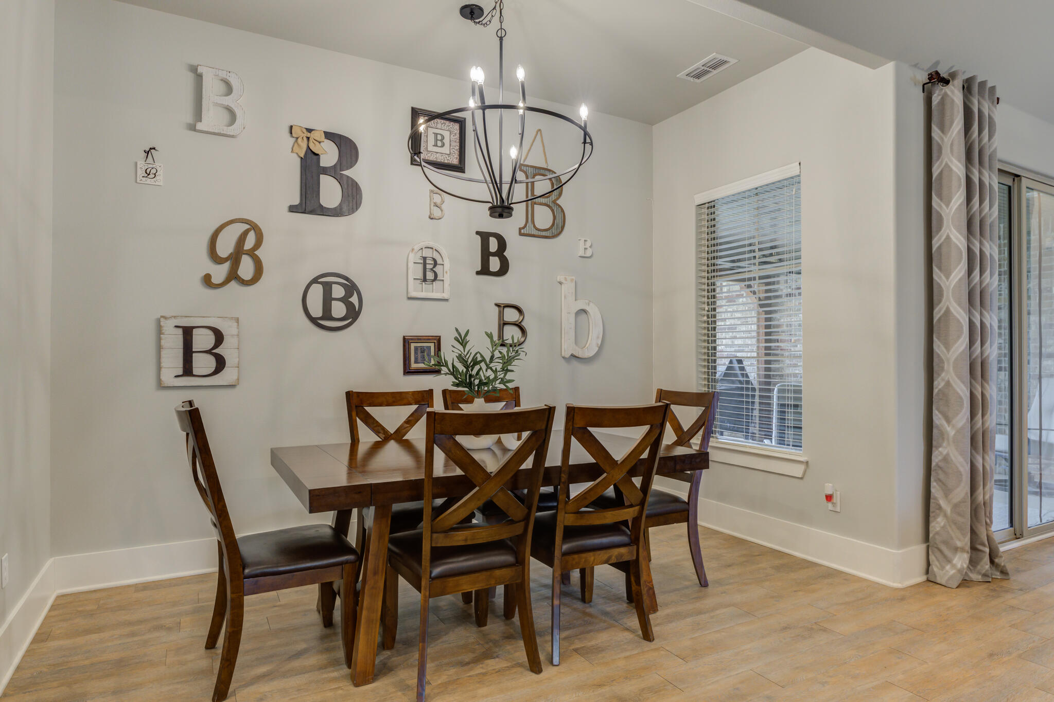 3918 137th Street Lubbock, TX 79423 - Photo 19 of 64 a view of a dining room with furniture and wooden floor
