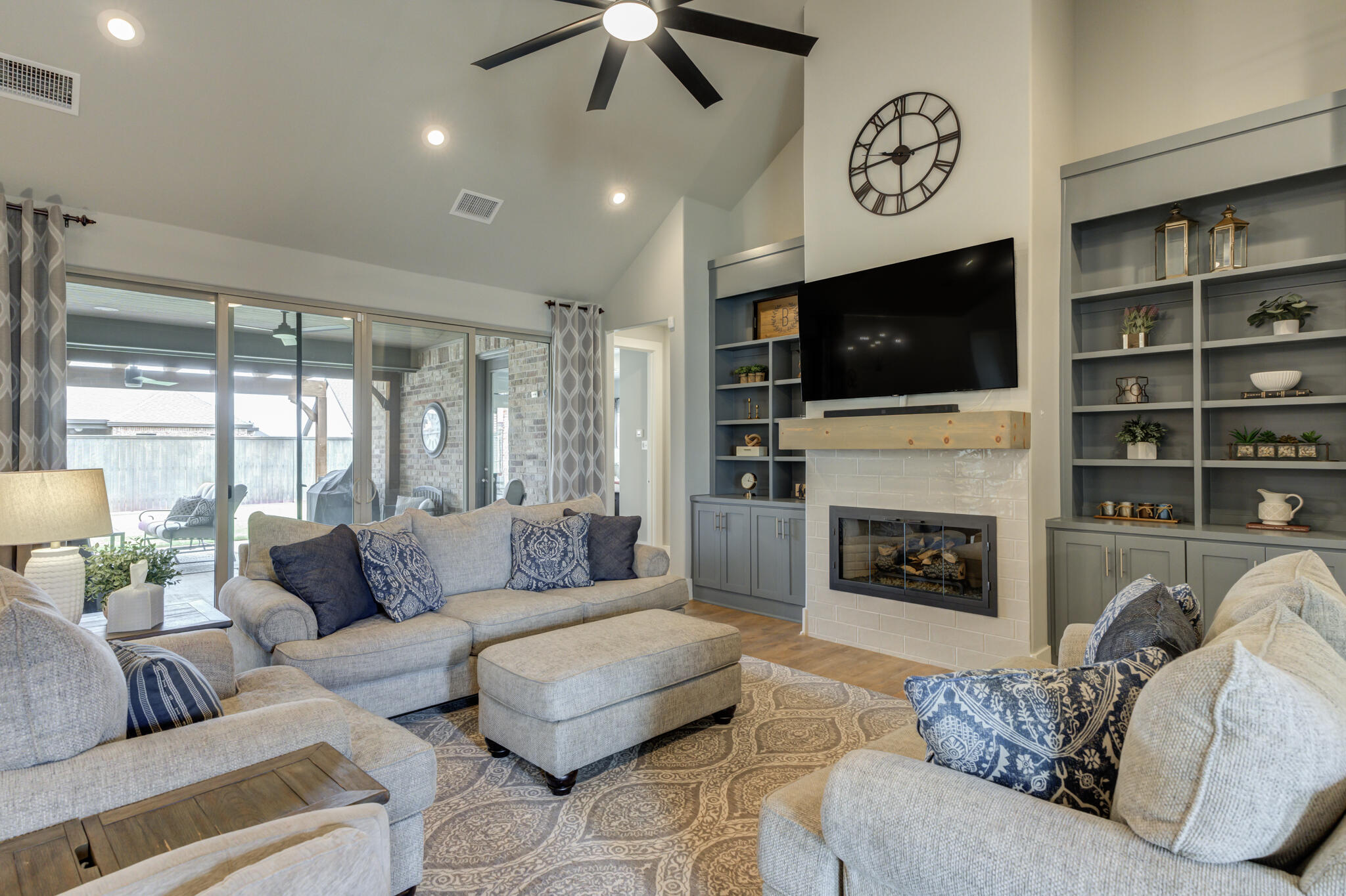 3918 137th Street Lubbock, TX 79423 - Photo 22 of 64 a living room with furniture a flat screen tv and a fireplace