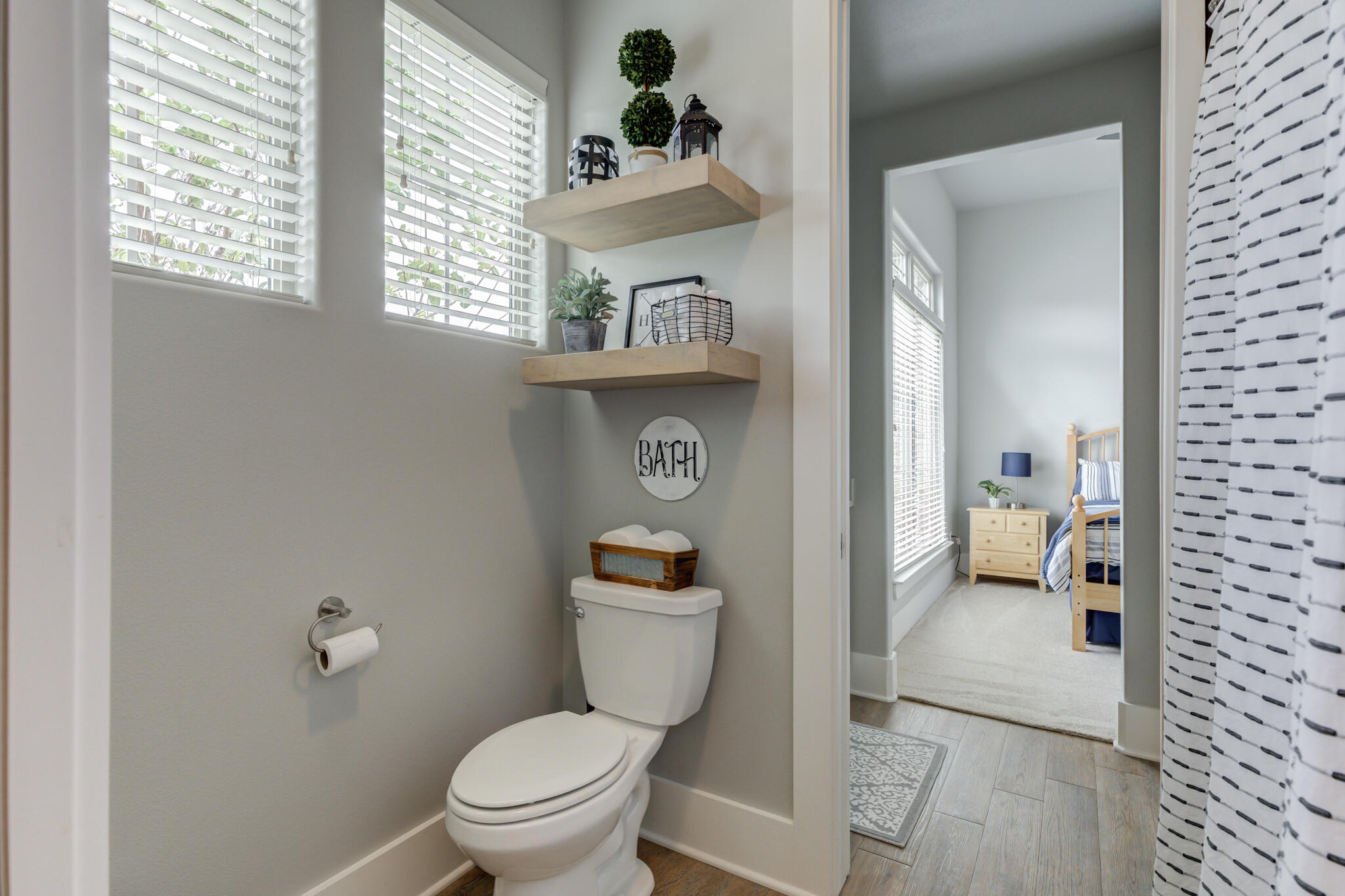 3918 137th Street Lubbock, TX 79423 - Photo 37 of 64 a bathroom with a toilet a sink and mirror