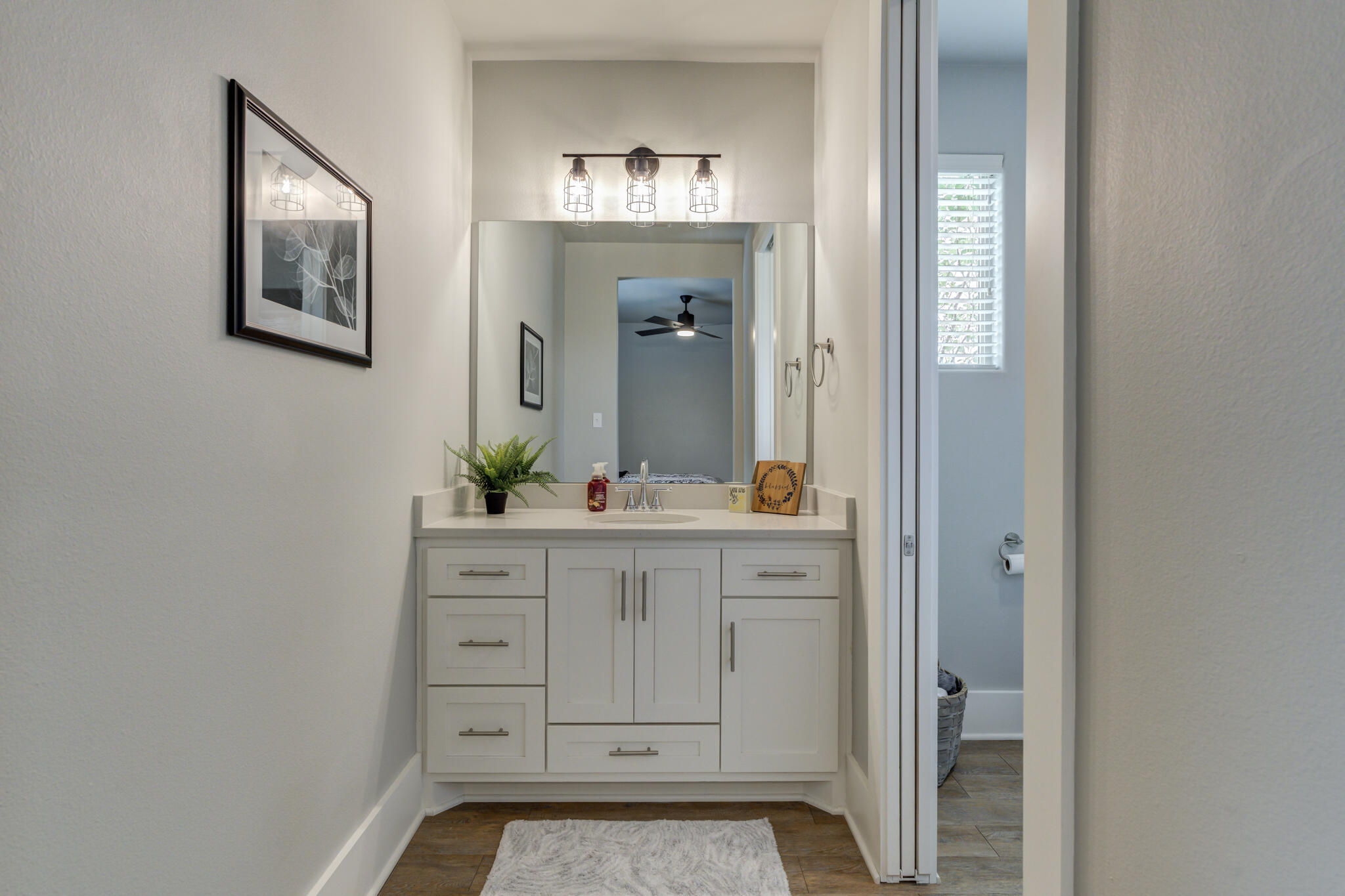 3918 137th Street Lubbock, TX 79423 - Photo 38 of 64 a bathroom with a sink and a mirror