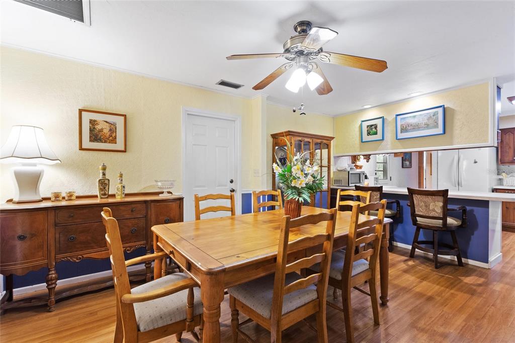 3641 Turtle Mound Road Melbourne, FL 32934 - Photo 14 of 77 a view of a dining room with furniture and wooden floor