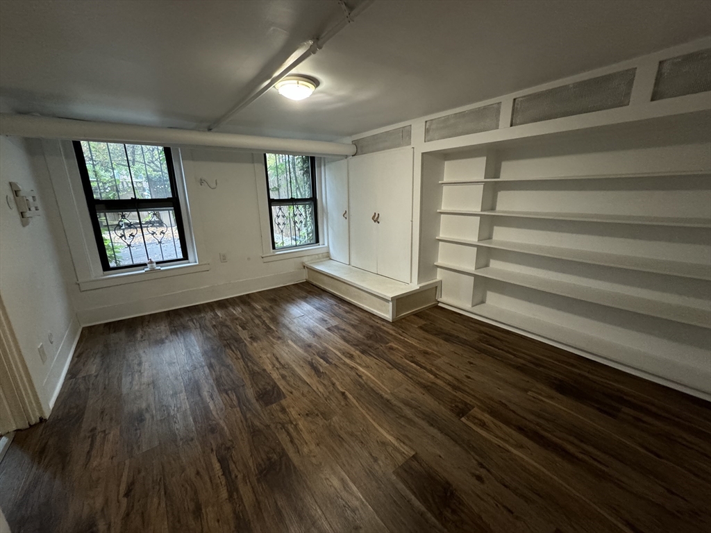 234 West Canton Street, Unit 1 Boston, MA 02116 - Photo 14 of 16 a view of an empty room with wooden floor and a window