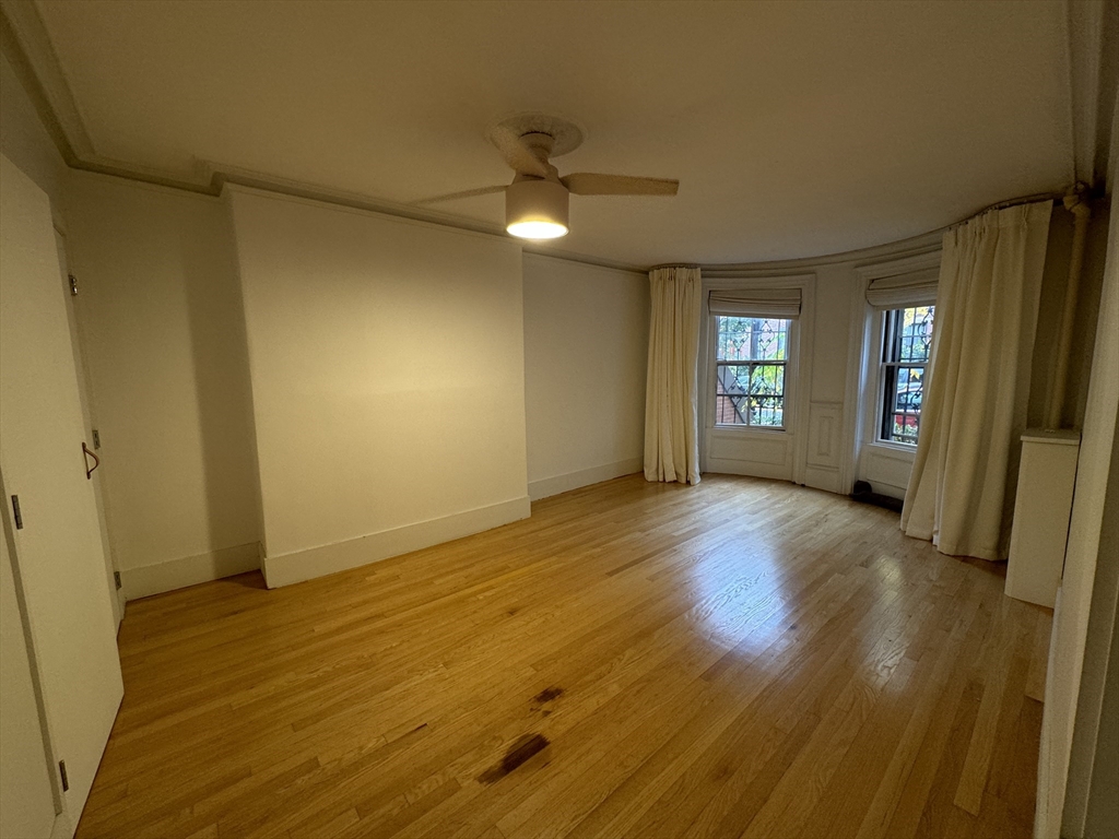 234 West Canton Street, Unit 1 Boston, MA 02116 - Photo 7 of 16 an empty room with wooden floor and windows
