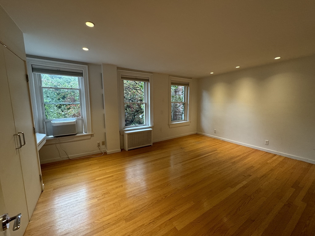 234 West Canton Street, Unit 1 Boston, MA 02116 - Photo 9 of 16 a view of an empty room with a window and wooden floor