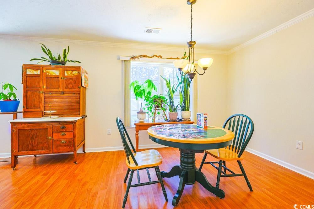 2033 Chadbury Lane Myrtle Beach, SC 29588 - Photo 11 of 39 Dining area with crown molding and light wood-type flooring