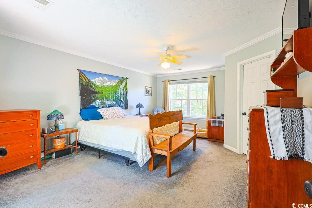 2033 Chadbury Lane Myrtle Beach, SC 29588 - Photo 16 of 39 Bedroom with carpet flooring, ornamental molding, and a ceiling fan