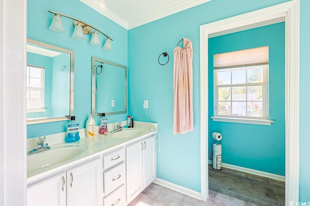 2033 Chadbury Lane Myrtle Beach, SC 29588 - Photo 19 of 39 Full bathroom featuring ornamental molding, double vanity, and light tile patterned floors