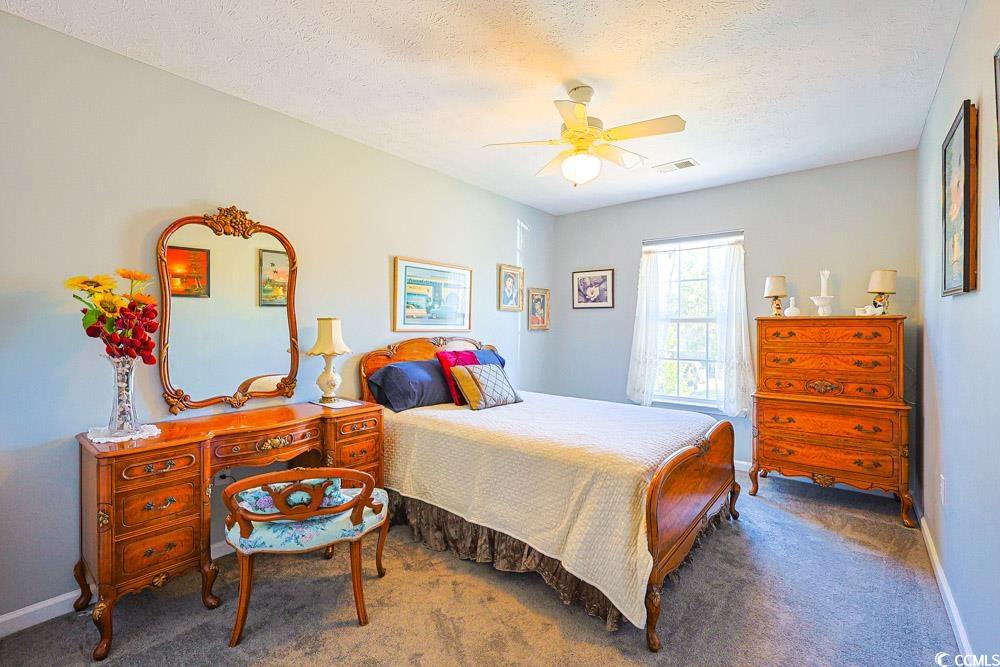 2033 Chadbury Lane Myrtle Beach, SC 29588 - Photo 20 of 39 Bedroom featuring carpet floors, a textured ceiling, and ceiling fan