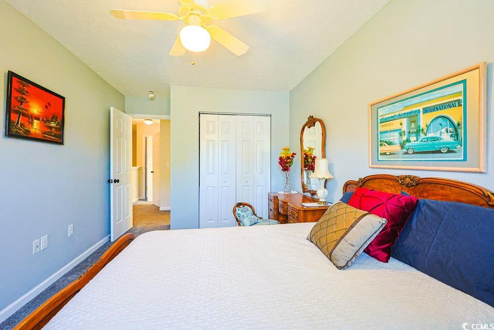 2033 Chadbury Lane Myrtle Beach, SC 29588 - Photo 21 of 39 Bedroom featuring a ceiling fan, a closet, and wood finished floors