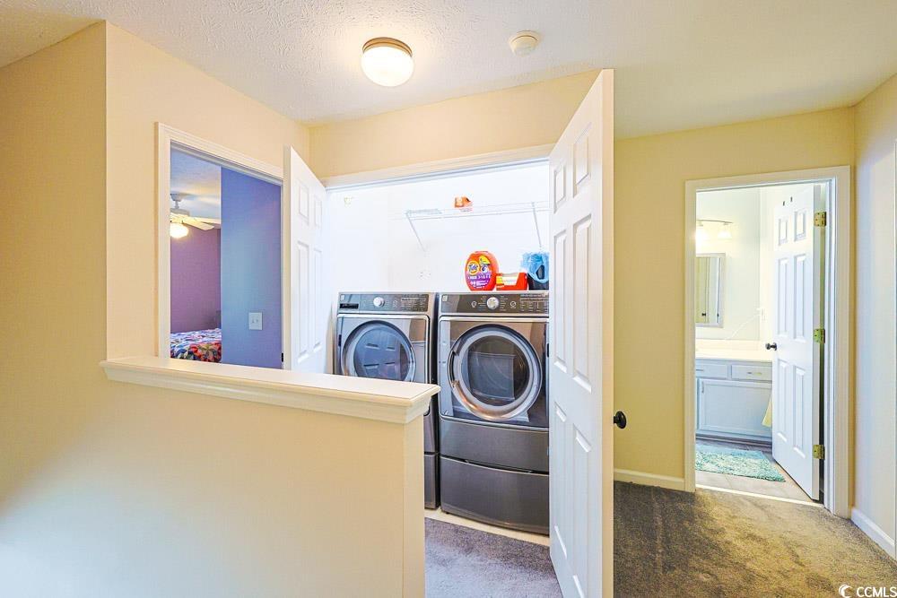 2033 Chadbury Lane Myrtle Beach, SC 29588 - Photo 22 of 39 Laundry room featuring dark carpet, washer and dryer, and a textured ceiling