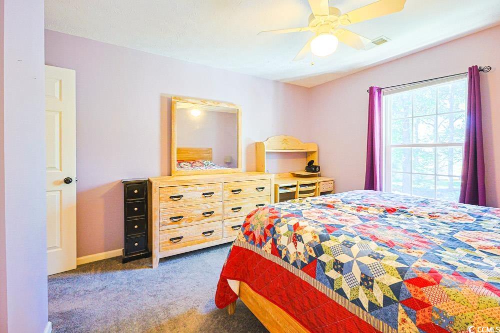2033 Chadbury Lane Myrtle Beach, SC 29588 - Photo 23 of 39 Bedroom with dark colored carpet and a ceiling fan
